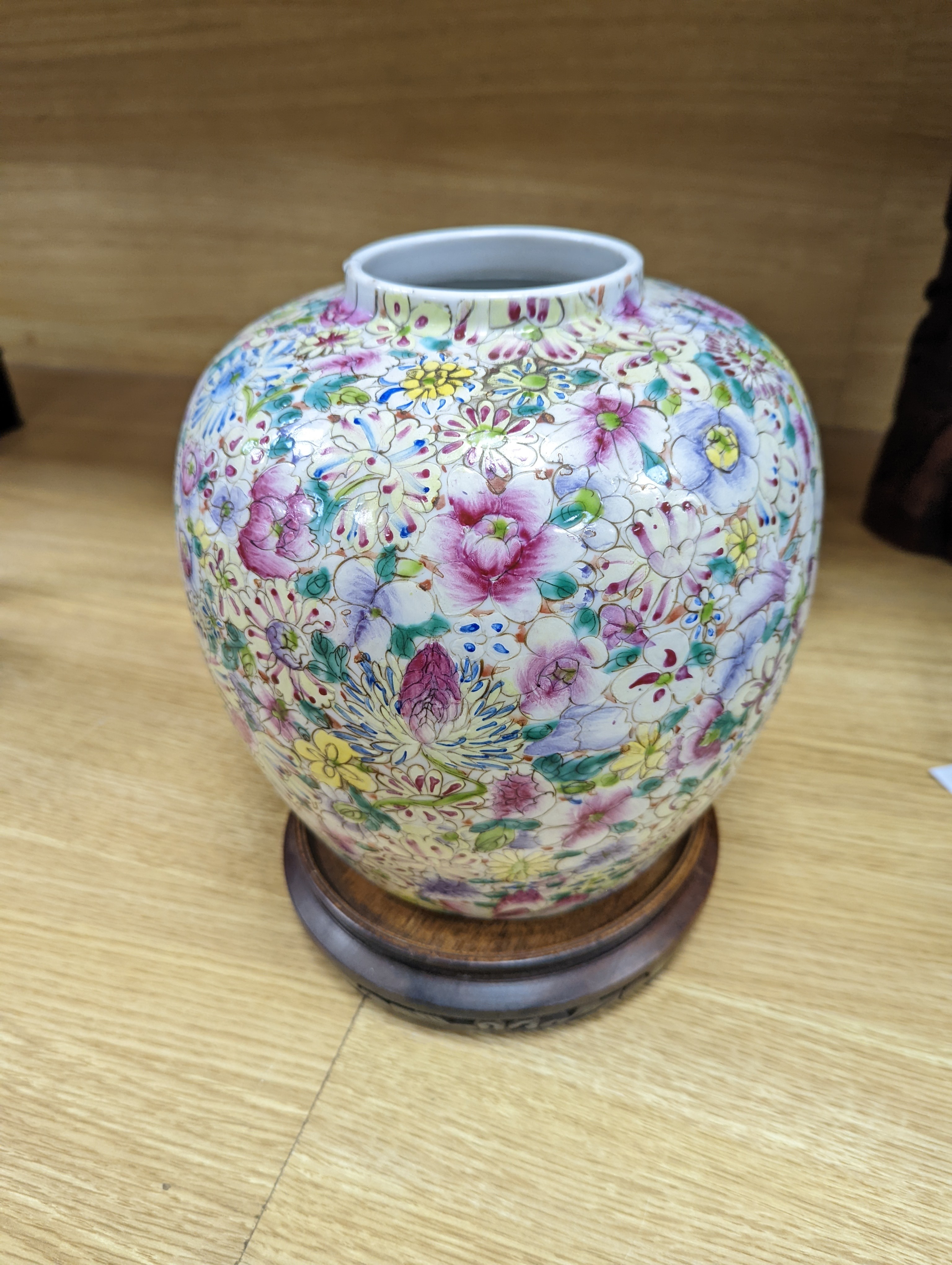 A Chinese thousand flower famille rose jar and cover, early 20th century, wood stand 28cm